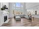 Spacious living room featuring a cozy fireplace and large windows at 78 Chatham Brook Dr, Westfield, IN 46074
