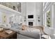 Living room with fireplace, built-in shelving and large windows with a view of the second floor at 78 Chatham Brook Dr, Westfield, IN 46074