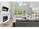 Bright living room features a fireplace, built-ins, and large windows with views of the landscaped lawn at 78 Chatham Brook Dr, Westfield, IN 46074