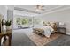 Spacious main bedroom featuring tray ceilings, large windows, and a cozy sitting area at 78 Chatham Brook Dr, Westfield, IN 46074
