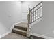 A carpeted stairway featuring a decorative wrought iron and wood railing in a neutral color palette at 78 Chatham Brook Dr, Westfield, IN 46074