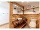 Stylish bathroom features rustic wood paneling, vessel sink, and modern lighting at 7906 Hampton Pl, Fishers, IN 46038