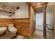 Rustic bathroom with wood paneling, modern fixtures, vessel sink, and an open shower at 7906 Hampton Pl, Fishers, IN 46038