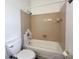 Bathroom featuring a tub with light tan tile, a shower head, white toilet, and neutral walls at 7906 Hampton Pl, Fishers, IN 46038
