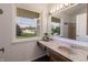 Bathroom featuring a window with a view, vanity, large mirror, and bright vanity lights at 7906 Hampton Pl, Fishers, IN 46038
