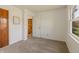 Bright bedroom featuring neutral carpet, fresh white walls, natural lighting, and a painted door at 7906 Hampton Pl, Fishers, IN 46038