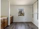 This bedroom features wood-look floors, a window, white walls, and closet organizers at 7906 Hampton Pl, Fishers, IN 46038