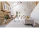 Bright living room featuring a stone fireplace, skylights, and modern furnishings, perfect for relaxation at 7906 Hampton Pl, Fishers, IN 46038