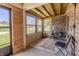 This sunroom features lots of natural light, wood paneling, brick wall and seating area at 7906 Hampton Pl, Fishers, IN 46038