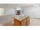 Kitchen with granite island, wood cabinets and view into living room at 7988 Kersey Dr, Indianapolis, IN 46236