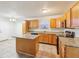 Kitchen with wood cabinets, granite countertops, and a large island at 7988 Kersey Dr, Indianapolis, IN 46236