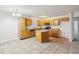 Kitchen boasts wood cabinets, granite countertops, and a breakfast bar at 7988 Kersey Dr, Indianapolis, IN 46236