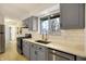 Modern kitchen with gray cabinets, quartz countertops, and stainless steel appliances at 88 Sherman Dr, Carmel, IN 46032