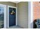 Dark blue front door with a pretty pink and green wreath at 9774 Herring Gull Dr, Carmel, IN 46280