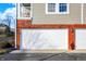 Two-car garage with white doors and brick exterior at 9774 Herring Gull Dr, Carmel, IN 46280