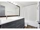 Stylish bathroom with a double vanity, gray cabinets, and a large mirror at 11010 Broadway St, Indianapolis, IN 46280