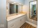 Bathroom with white vanity, stone countertop, and walk-in shower at 1601 Spruce St, Indianapolis, IN 46203
