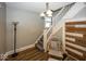 Entryway featuring hardwood floors, staircase, and coat rack at 1601 Spruce St, Indianapolis, IN 46203