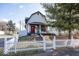 Charming white house with a red door, front porch, and picket fence at 1601 Spruce St, Indianapolis, IN 46203