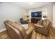 Spacious living room with leather furniture, fireplace, and large TV at 1601 Spruce St, Indianapolis, IN 46203
