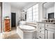 Spa-like bathroom with soaking tub, double sinks, and large mirrors at 2045 Finchley Rd, Carmel, IN 46032