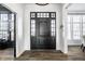 Bright entryway with dark hardwood floors and a black door at 2045 Finchley Rd, Carmel, IN 46032