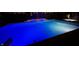 Stunning nighttime view of a large in-ground pool with blue LED lighting at 2045 Finchley Rd, Carmel, IN 46032