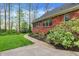 Stone walkway leads to the side of the house, with lush landscaping, creating a private outdoor retreat at 1398 Penny Ln, Greenfield, IN 46140