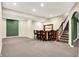 Finished basement with carpeted floors, accent lighting, bar with seating, and stairway at 1398 Penny Ln, Greenfield, IN 46140