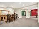 Finished basement with bar and seating, carpeted floors, and open archways into other rooms at 1398 Penny Ln, Greenfield, IN 46140