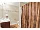 Bathroom featuring tiled floors, vanity, toilet, shower, and accent wallpaper border at 1398 Penny Ln, Greenfield, IN 46140