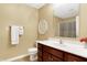 Clean bathroom with dark wood vanity, white countertop, and shower/tub combo at 1398 Penny Ln, Greenfield, IN 46140
