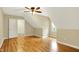Brightly lit bedroom with hardwood floors, angled ceiling, and trim accents on walls at 1398 Penny Ln, Greenfield, IN 46140
