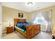Cozy bedroom with wood framed bed and window seat at 1398 Penny Ln, Greenfield, IN 46140