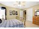 Bright bedroom with brass bed, ceiling fan, and ample closet space at 1398 Penny Ln, Greenfield, IN 46140