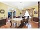 Elegant dining room featuring a formal table setting, hardwood floors, and a chandelier at 1398 Penny Ln, Greenfield, IN 46140