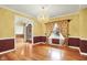 Dining room with hardwood floors, decorative molding, and a window letting in natural light at 1398 Penny Ln, Greenfield, IN 46140