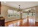 Bright dining room with hardwood floors, large windows, and decorative chandelier at 1398 Penny Ln, Greenfield, IN 46140