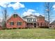 Brick two-story house with green shutters, a large front yard, and a wrap-around porch at 1398 Penny Ln, Greenfield, IN 46140