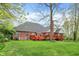 Beautiful brick home with a large wooden deck, overlooking a well-maintained lawn and lush green surroundings at 1398 Penny Ln, Greenfield, IN 46140