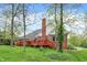 Charming brick home exterior with a spacious wooden deck, perfect for outdoor entertaining and relaxation at 1398 Penny Ln, Greenfield, IN 46140