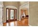Inviting foyer with hardwood floors and a decorative glass front door leading to formal living spaces at 1398 Penny Ln, Greenfield, IN 46140