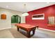 Spacious game room with pool table, accent lighting, carpeted floors, and open archways at 1398 Penny Ln, Greenfield, IN 46140