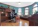Spacious home office with built-in shelving and hardwood floors at 1398 Penny Ln, Greenfield, IN 46140