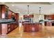 Gourmet kitchen with dark cabinetry, stainless steel appliances, large island, and hardwood floors at 1398 Penny Ln, Greenfield, IN 46140