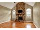 Vaulted living room with a stone fireplace, hardwood floors, and natural light at 1398 Penny Ln, Greenfield, IN 46140