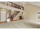 Spacious living room with high ceilings, staircase, and large windows for ample natural light at 1398 Penny Ln, Greenfield, IN 46140