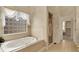 Main bathroom features a large soaking tub, tiled floor, and separate glass shower at 1398 Penny Ln, Greenfield, IN 46140