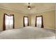 Large main bedroom featuring neutral carpet and large windows with decorative curtains at 1398 Penny Ln, Greenfield, IN 46140