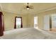 Spacious main bedroom with carpet, tray ceilings, and an attached bathroom at 1398 Penny Ln, Greenfield, IN 46140